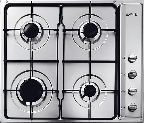 Cooker hob with burners being cleaned